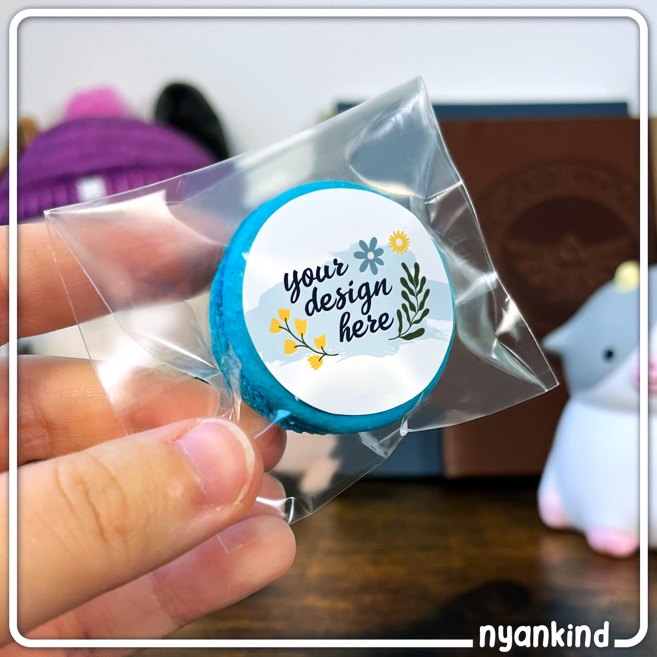 Small plastic bag with blue macaron and "Your Design Here" label