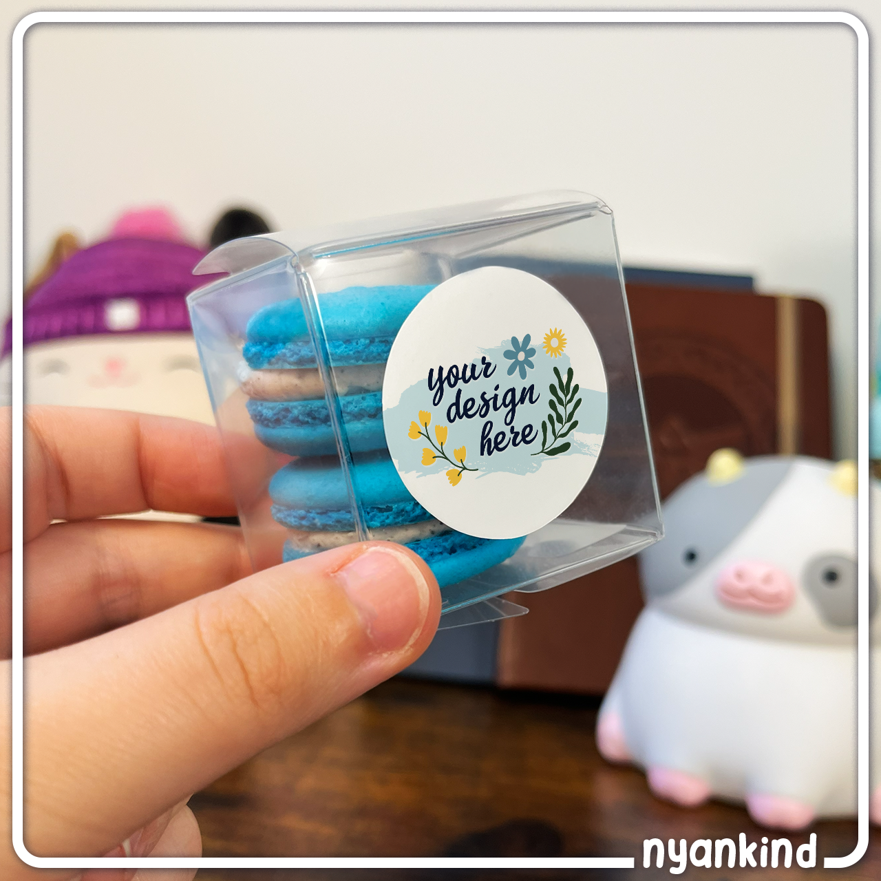 2x2 inch plastic packaging with blue macarons and "Your Design Here" label